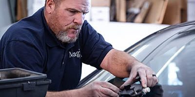 technician performing windshield repair.